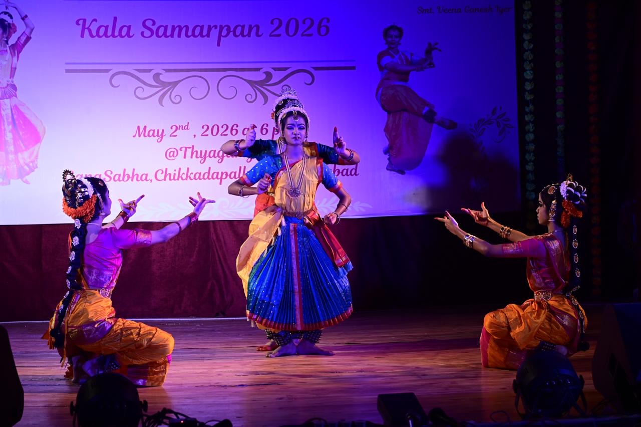 Dancers performing under blue stage lighting